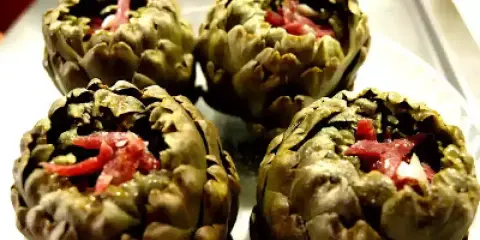 Cuatro alcachofas rellenas de jamón, listas para disfrutar.