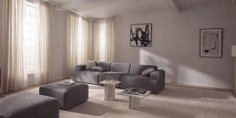 Nowoczesny salon z szarą sofą i pufami, inspiracja jak uzyskać kolor grafitowy w aranżacji.