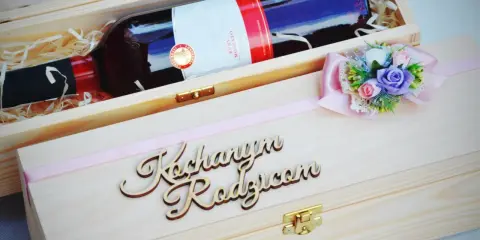 Elegancka skrzynka na wino dla chrzestnych z napisem "Kochanym Rodzicom" i ozdobną kokardką z kwiatami.