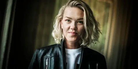Ana Diaz, med sitt blonda hår och svarta läderjacka, ser ut som en stark kvinna som kan hantera vad som helst, kanske till och med sina egna barn.