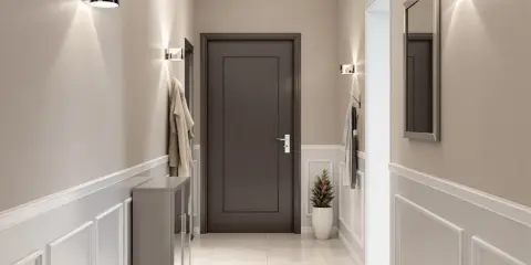 Nowoczesny przedpokój z praktycznymi ścianami ozdobionymi sztukaterią. Dyskretne oświetlenie i lustro dodają elegancji.