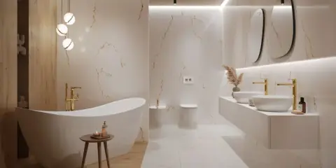 Jasna, nowoczesna łazienka z wolnostojącą wanną, złotymi bateriami i designerskimi umywalkami.