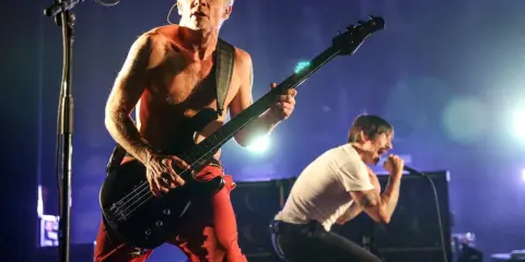 Flea spelar bas och Anthony Kiedis sjunger på scenen under en konsert med Red Hot Chili Peppers i Sverige.