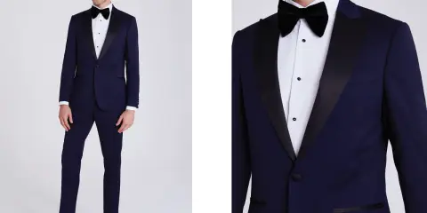 A man models a navy tuxedo with black satin lapels. Inquire about how much are tuxedos rentals for your next formal event.