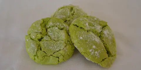 Trois biscuits verts craquelés, saupoudrés de sucre glace. Parfait pour savoir que faire avec des macarons ratés.
