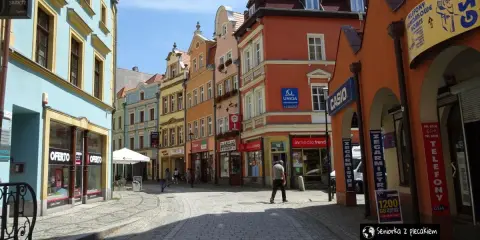 Kolorowe kamienice i brukowana uliczka tworzą urokliwy zakątek, idealny do odkrywania atrakcji Jeleniej Góry.