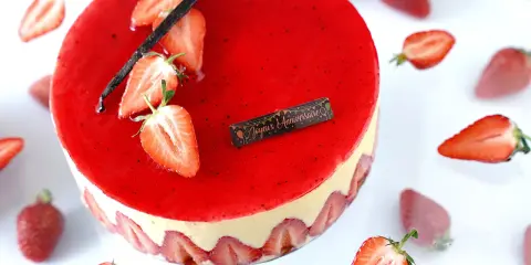 Gâteau fraisier à la crème mousseline, décoré de fraises fraîches et d'une gousse de vanille. Parfait pour une recette d'anniversaire.