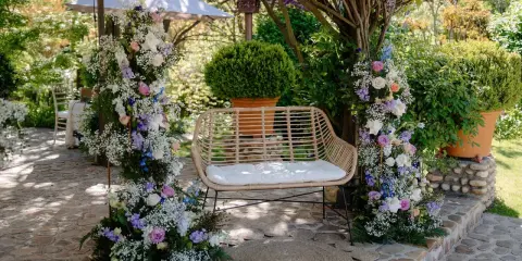 Un rincón idílico para bodas con arcos florales, un banco de mimbre y detalles rústicos. ¡Ideas originales boda!