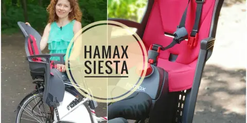 Kobieta prezentuje fotelik rowerowy Hamax Siesta, idealny do bezpiecznych podróży z dzieckiem.