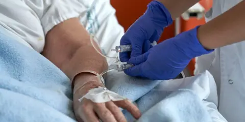 Pielęgniarka podaje lek przez wenflon. Cewnik silikonowy co ile wymieniać zależy od zaleceń lekarza.