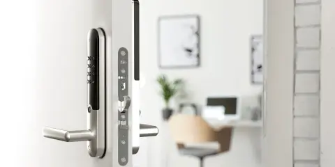 Close-up of a Yale Doorman L3 smart lock on a white door, showing the keypad and handle.
