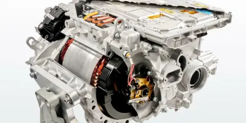 Cutaway view of an electric car motor, showing internal components like the rotor, stator, and power electronics.