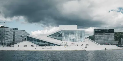 Nowoczesna architektura Opery w Oslo, gdzie prawo jante jest widoczne w kaskadowych, białych dachach schodzących do wody.