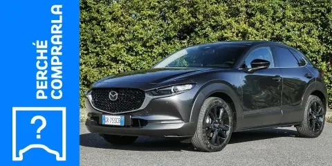 Mazda CX-30 grigia parcheggiata, con testo "Perché comprarla" e un punto interrogativo. Valutazione dei **problemi** della Mazda CX-30.