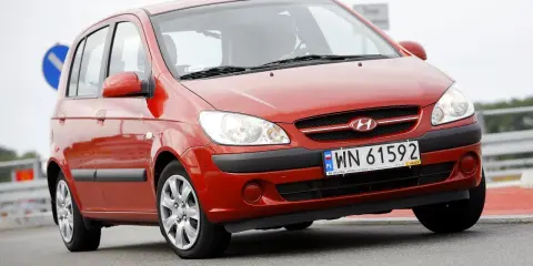 Czerwony Hyundai Getz 1.1 z polskimi tablicami WN 61592 na drodze.