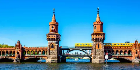 Oberbaumbrücke in Berlin: Ein Muss für jeden Besucher. Eine gelbe U-Bahn fährt über die historische Brücke, die mit ihren Türmchen und Bögen beeindruckt.