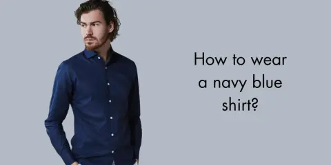 Man in a navy blue shirt and white pants, asking "How to wear a navy blue shirt?".