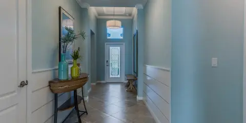 Corridoio con pareti azzurre e pannelli bianchi. Il colore pareti corridoio buio è un azzurro tenue che illumina lo spazio.