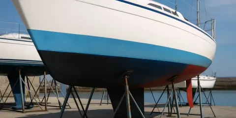 Coques de voiliers sur bers. La bande bleue et la partie inférieure noire de la coque arborent une belle couleur antifouling.