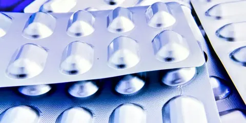 Blistry z lekami, które mogą pomóc na depresję. Srebrne opakowania leków w zbliżeniu.