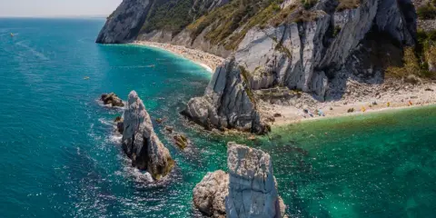 Scogliere bianche e mare turchese, una spiaggia affollata e kayak: ecco cosa vedere a Civitanova Marche per una vacanza indimenticabile.