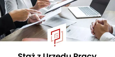 Rozmowa kwalifikacyjna. Dwie osoby analizują dokumenty, obok laptop i CV. To szansa na staż z Urzędu Pracy.