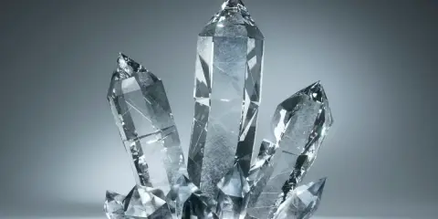 Klarowne, wielościenne kryształy o ostrych wierzchołkach, tworzące skupisko. Tak wygląda kryształ, gdy światło przechodzi przez jego fasetki.