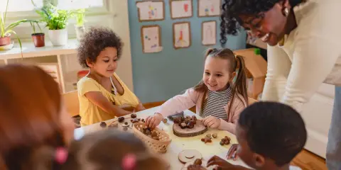 Kinder lernen spielerisch mit Naturmaterialien, ein Beispiel für Freinet Pädagogik.