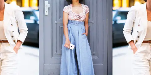Moda: pantaloni high waist significato. Due donne con outfit eleganti, una con blazer bianco e pantaloni chiari, l'altra con crop top floreale e ampi pantaloni azzurri.