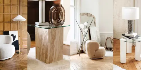 Arredamento vintage casa: poltrone soffici, tavolini in travertino e vetro, lampade di design e specchi antichi creano un'atmosfera accogliente.