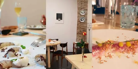 Un'elegante cena in un ristorante a Rimini. Piatti raffinati, bicchieri di vino e un'atmosfera accogliente con dettagli artistici.