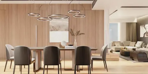 Nowoczesne oświetlenie salonu inspiracje: wiszące lampy nad stołem, drewniane panele i przytulna strefa wypoczynkowa.
