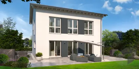 Moderne Stadtvilla mit Satteldach, großen Fenstern und einer gemütlichen Terrasse mit Lounge-Möbeln.