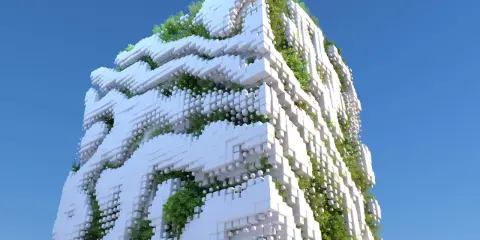 Edifici ecosostenibili con facciate a blocchi bianchi e vegetazione rigogliosa che si intreccia, sotto un cielo azzurro.