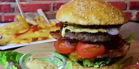 Soczyste mięso na burgery, świeże warzywa i chrupiące frytki tworzą idealny zestaw.