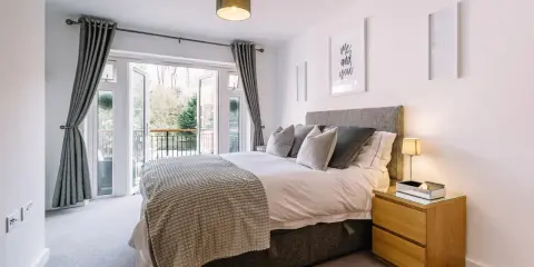 Chambre lumineuse avec lit douillet, accès balcon et décoration murale "Me and you". Idéal pour louer une partie de sa résidence principale.