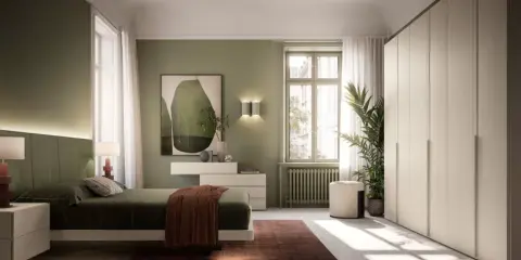 Camera da letto con accogliente **parete verde salvia**. Letto comodo, armadio capiente e un quadro astratto completano l'ambiente.