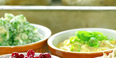 Olika skålar med bakad potatis fyllning: krusbär, gräslök och en grön fyllning.