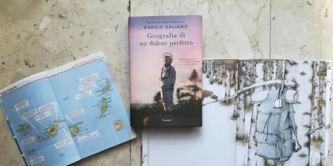 Mappa delle Canarie, libro "Geografia di un dolore perfetto" e illustrazione di uno zaino in un bosco innevato.