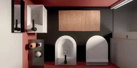 Bagno moderno con wc e bidet di fronte, tappeto in juta e lavabo squadrato.