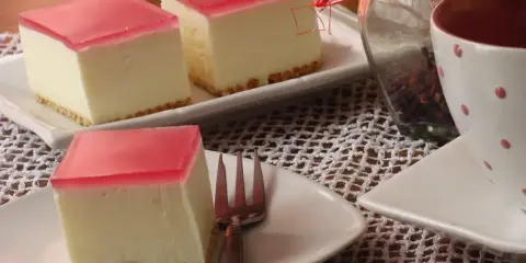 Pyszny sernik na zimno z wiaderka, z galaretką wiśniową, gotowy do podania. Idealny deser na letnie popołudnie.