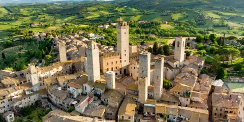 Aerial view of San Gimignano, Italy, with its medieval towers and Tuscan countryside.