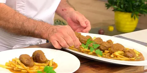 Carrilleras de cerdo en olla express, al estilo Arguiñano, servidas con patatas fritas y perejil.