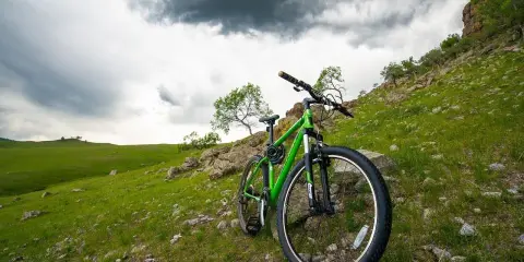 Zielony rower 26 cali na jaki wzrost? Idealny na górskie wyprawy, czeka na przygodę pod burzowym niebem.