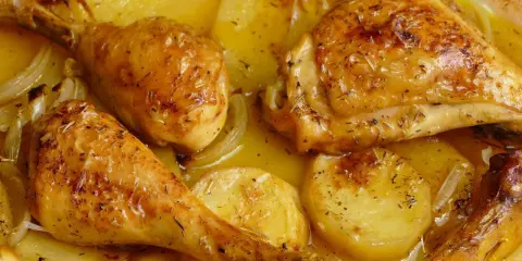 Pollo asado con patatas y cebolla, una de las mejores recetas con pollo para disfrutar en familia.