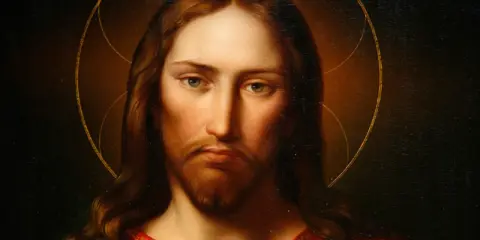 Porträt von Jesus von Nazareth mit Heiligenschein und rotem Gewand. Sein Blick ist nachdenklich und sanft.
