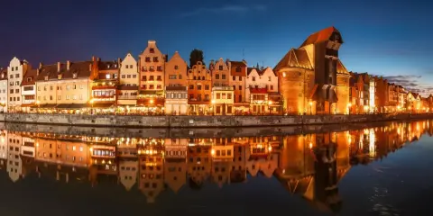 Nadmorska panorama Gdańska nocą, z odbijającymi się w wodzie kamienicami i Żurawiem. Idealne miejsce na zaręczyny Polska.