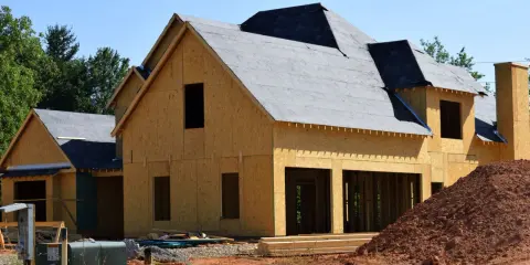 Construction d'une maison en bois, prête à moderniser une maison existante. Le toit est recouvert de feutre, les murs sont en panneaux OSB.
