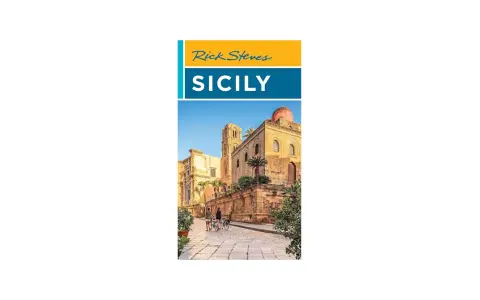Rick Steves Sicily: A sun-drenched street in Sicily with ancient architecture and two people on bicycles, hinting at an unforgettable journey.