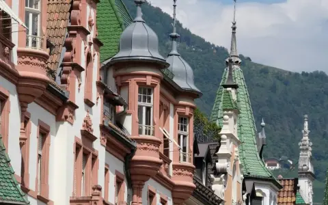 Edifici storici con tetti verdi e torrette a Bolzano, un assaggio di **Bolzano in un giorno**.